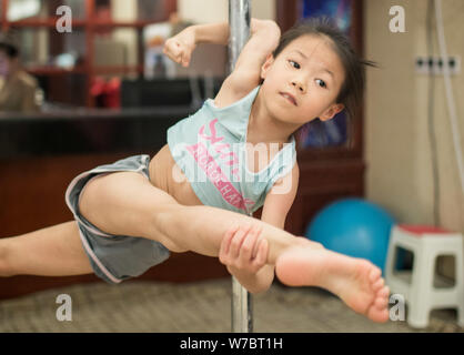 A six-year-old girl performs pole dance in a class being offered to