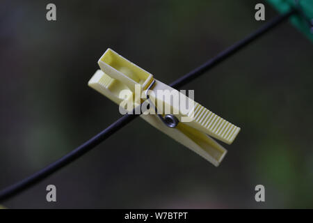 Plastic clothes pegs on a wire Stock Photo