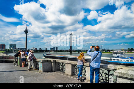 the Rhine river seen from the Düsseldorf Rheinuferpromenade with view og the cable-stayed Rheinkniebrücke the Rheinturm telecommunications tower, Düss Stock Photo