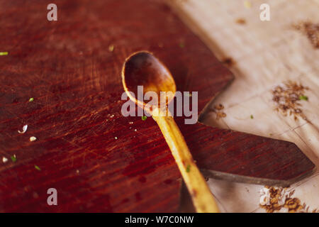 Shallow depth of field image with a wooden cutting board and a wooden spoon Stock Photo