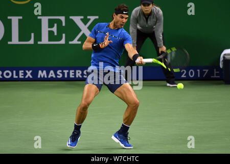 Rafael Nadal of Spain returns a shot to Marin Cilic of Croatia in their semifinal of men's singles during the Shanghai Rolex Masters tennis tournament Stock Photo