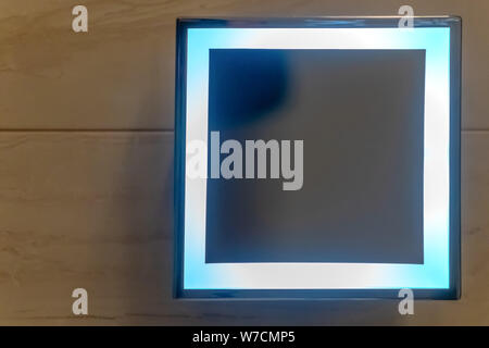 Square shape mirror with LED light mounth on white wall in restroom. Square mirror in the bathroom. Stock Photo