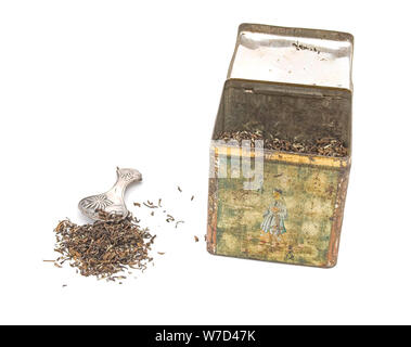 Himalayan tea in old tea tin with antique silver teaspoon and some tealeaves Stock Photo