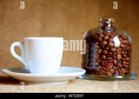 White cup with coffee on a blurred background. Stock Photo