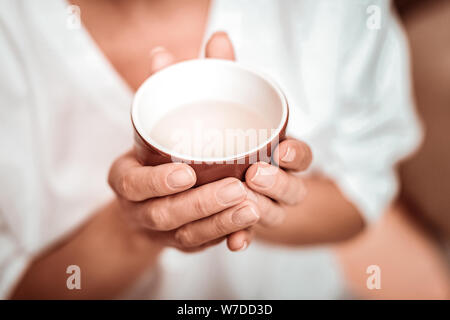 Cup of fragrant herbal tea before drinking. Stock Photo