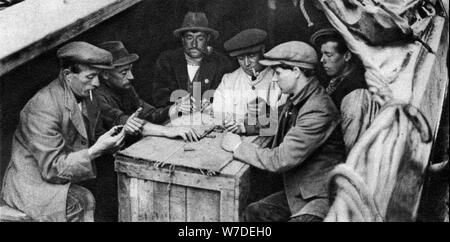 A bargee and his mates play dominoes in the hold of a canal boat, 1926-1927. Artist: Unknown Stock Photo