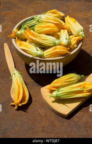 Fresh organic  squash Yellow flower  in wooden plate  on iron rustic  background Stock Photo