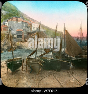 Fishing fleet at low tide, Polperro, Cornwall, late 19th or early 20th century. Artist: Church Army Lantern Department Stock Photo