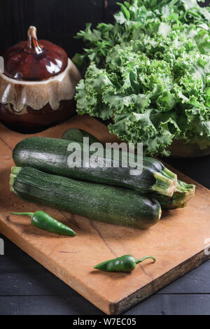 Fresh vegetables on a wooden board. Zucchini. Vegan food. Stock Photo