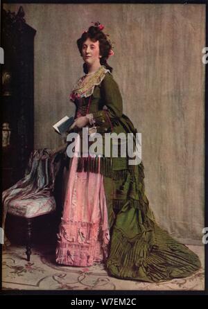 'An afternoon dress of green and pink silk. Very typical of the modes between 1868 and 1878', c1913. Artist: Unknown. Stock Photo