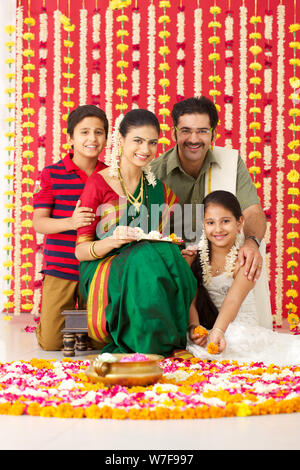 Portrait of a South Indian family making rangoli Stock Photo