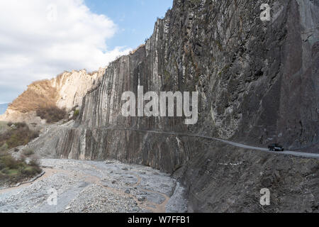 Lahic, Ismayilli region, Azerbaijan - April 27, 2019. Mountainous road leading to Lahic village in Ismayill region of Azerbaijan, with car. Stock Photo