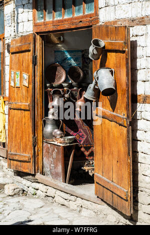 Lahic, Ismayilli region, Azerbaijan - April 28, 2019. Entrance to a coppersmith shop in Lahic village of Azerbaijan, with wooden doors and metalwork. Stock Photo