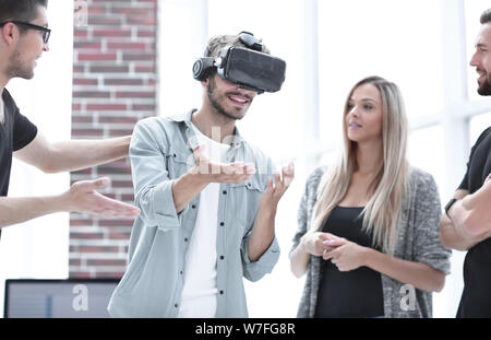 Positive colleagues testing virtual reality glasses Stock Photo