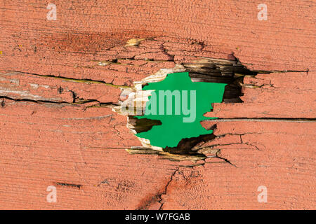 Hole In Board with Green Background Stock Photo
