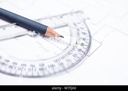 Pencil on a transparent protractor against the background of drawing details Stock Photo