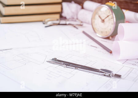 Books on architecture, a few crumpled drawings, glasses on the table in the architect Stock Photo