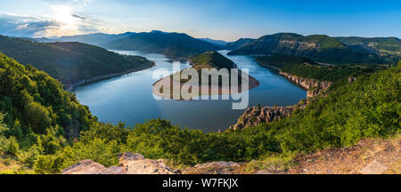 Bulgaria, Kurdjali dam, aerial view of meander in Arda river, surrounded with green forest, summer time during sunset Stock Photo