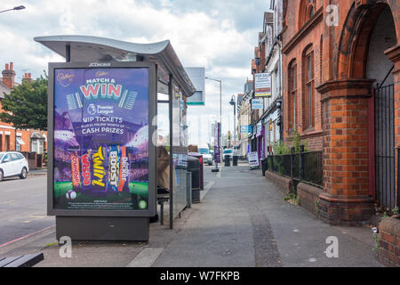 A bus shelter with a JCDecaux advertising board on the side on the pavement alongside Oxford Road in Reading, Berkshire, UK Stock Photo