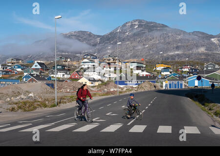 Mother and child cycling in Nuuk, the capital of Greenland. Stock Photo