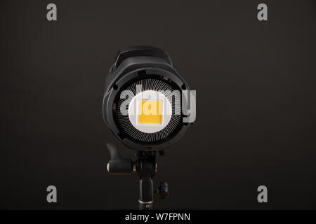 studio light flash lamp closeup on black background. View to matrix of profrssional flash lapmp constant light Stock Photo