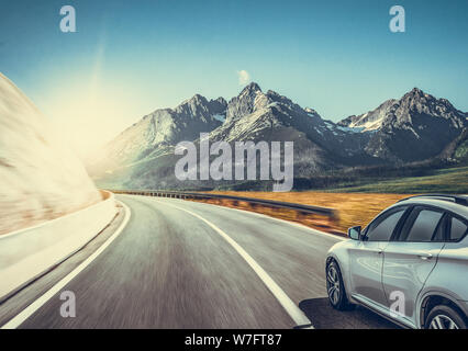 Highway among the mountain scenery. White car on a mountain road. Stock Photo
