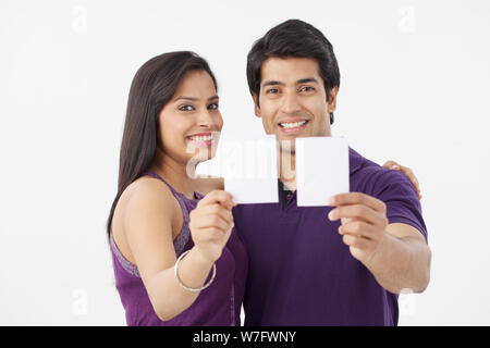 Portrait of a couple showing blank cards Stock Photo