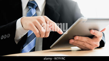 Close up of businessman hands using tablet and technology, Online working, connecting internet with digital documents. Stock Photo