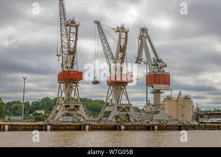 Dockside gantry cranes is use in the wharfs beside the Garonne River, Bordeaux, France. Heavy lift cranes within the industrial estate. Stock Photo