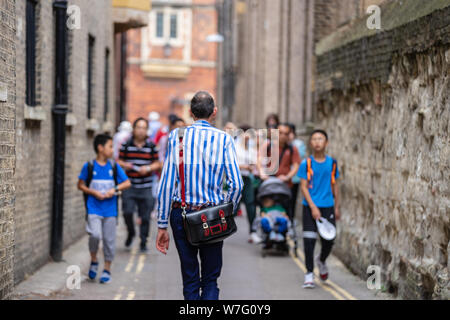 Stylish men walking down the street. Rear view of Stylish men walking at Cambridge Stock Photo
