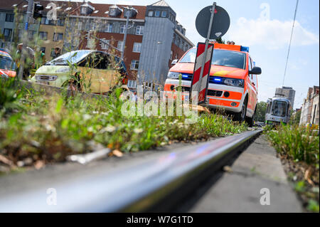 06 August 2019, Lower Saxony, Hanover: A car (l) stands on the street next to a fire truck after it was hit by a tram. Photo: Christophe Gateau/dpa Stock Photo