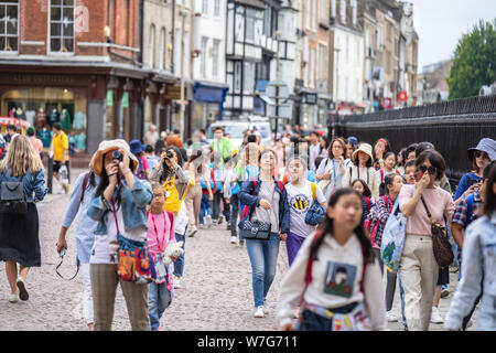 Cambridge, UK, August 1, 2019. Turists walking down and taking pictures at the street of Cambridge on a busy sunny day in front of Kings College Stock Photo