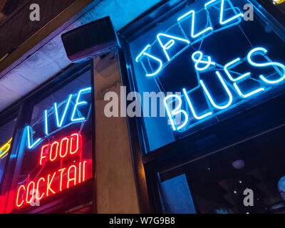 Chicago, Illinois USA. May 10, 2019.  Nightlife with Jazz and Blues music. Retro bar with red and blue neon sign. Food and coctails