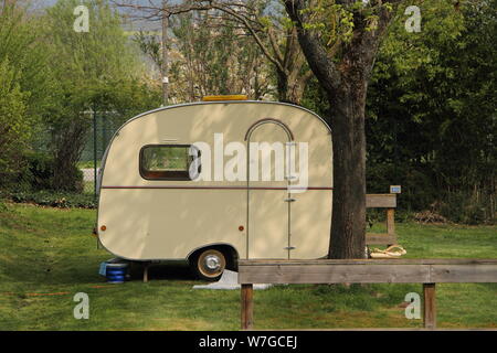 An old little caravan in the woods Stock Photo