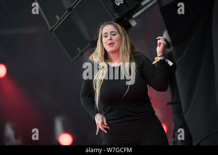 BONTIDA, ROMANIA - JULY 18, 2019: Sign language interpreter translating a song for persons with hearing impediment at Electric Castle festival Stock Photo