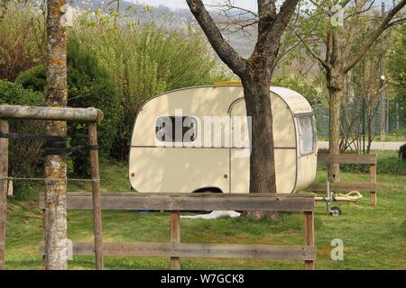 An old little caravan in the woods Stock Photo