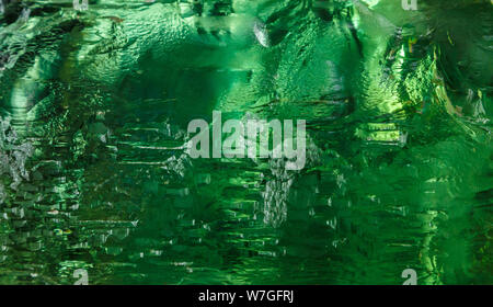 Close up of cut crystal in mysterious emerald light.Magic shiny background. Abstract. Stock Photo