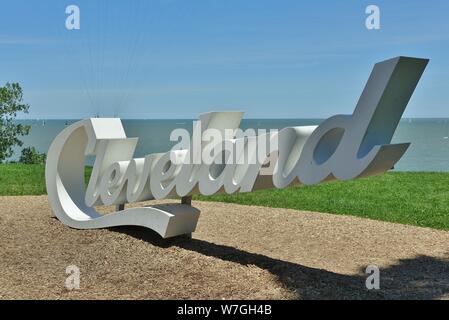 CLEVELAND, OH -23 JUN 2019- View of the Cleveland sign in front of the skyline of Cleveland, Ohio on the shore of Lake Erie. Stock Photo