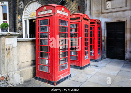 Three iconic traditional red British telephone boxes in London, England, UK Stock Photo