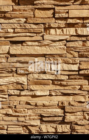Rock stone brick tile wall has a detailed background texture sepia cream brown color stacked in layers, you can use this image as a background image w Stock Photo