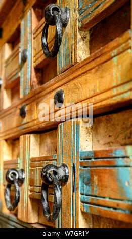 Details of a wooden chest made of recycled old ship planks with rivets and metal rings. Stock Photo