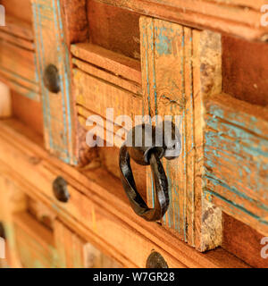 Details of a wooden chest made of recycled old ship planks with rivets and metal rings. Stock Photo