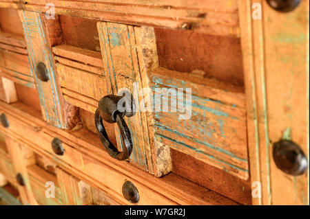 Details of a wooden chest made of recycled old ship planks with rivets and metal rings. Stock Photo