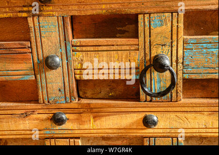 Details of a wooden chest made of recycled old ship planks with rivets and metal rings. Stock Photo