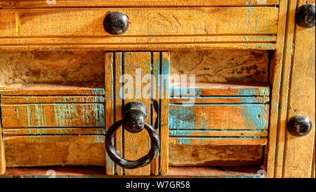 Details of a wooden chest made of recycled old ship planks with rivets and metal rings. Stock Photo