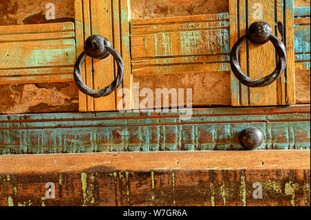 Details of a wooden chest made of recycled old ship planks with rivets and metal rings. Stock Photo