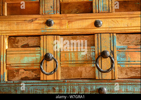 Details of a wooden chest made of recycled old ship planks with rivets and metal rings. Stock Photo