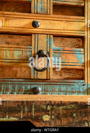 Details of a wooden chest made of recycled old ship planks with rivets and metal rings. Stock Photo