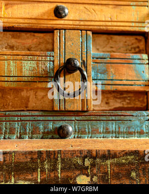 Details of a wooden chest made of recycled old ship planks with rivets and metal rings. Stock Photo