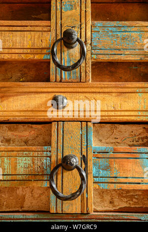 Details of a wooden chest made of recycled old ship planks with rivets and metal rings. Stock Photo